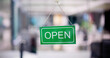 © Andrey Popov - Male Owner Holding Open Sign
