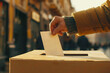 Close-up of a hand casting a ballot into a voting box, election day atmosphere 