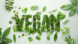 Green word 'VEGAN' formed from fresh leaves and vegetables