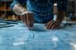 © xadartstudio - Close-up on the hands of a designer placing a digital marker on a virtual blueprint