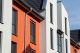 Fototapeta  - Mehrfamilienhaus mit schönem Fassadenanstrich in Weiß und mediterranem Orangeton