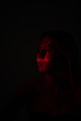 Shine a red laser in the shape of a cross at the girl. Future and virtual reality concept