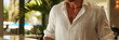 close shot of concierge at Palm Springs hotel reception desk, cool boutique hotel, shirt unbuttoned