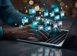 © adobe st - A businessman's hands working on a laptop with a digital document management system concept, using a computer for virtual documents and company information, displaying multiple financial file icons in
