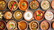 © Erzsbet - table filled with bowls of different soups and sauses from different countries cousine with vegetables or meat