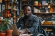 © Larisa AI - A confident African American man in a wheelchair is working on his laptop in a cozy cafe setting