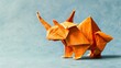   A close-up of an origami dog on a blue surface with a light blue background
