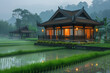 An Asian-style house surrounded by rice fields on a foggy evening
