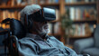 Disabled old black man with grey hair sitting on a wheelchair, wearing a virtual reality headset