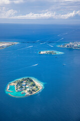 Beautiful aerial view on male the capital city of Maldives. Overcrowded island in Indian ocean blue ocean sea background. Exotic travel destination, airplane window view. Summer travel vacation design