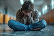 © Larisa AI - In a heartbreaking depiction, a distressed individual is seen sitting alone on a school floor, head buried in knees