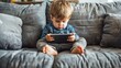 A toddler sits on a couch and watches a video on a tablet