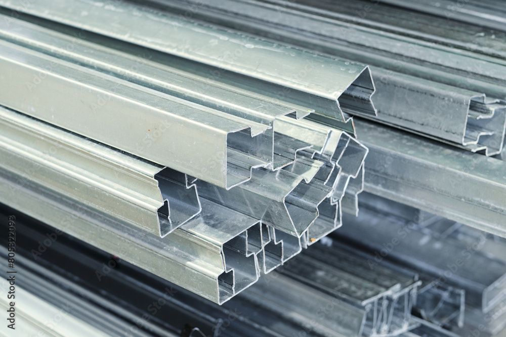 Metal steel square piping pipes stacked up on an industrial heavy duty ...