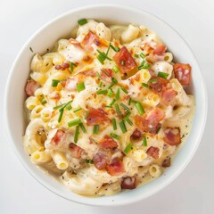 Wall Mural - A white bowl overflows with macaroni and cheese, topped with crispy bacon pieces