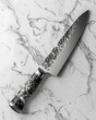 3D rendered luxury kitchen knife with creative details 3D generated, ad mockup isolated on a white and gray background.