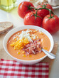 Creamy Spanish cold tomato and bread soup called salmorejo with diced ham and chopped egg on top.