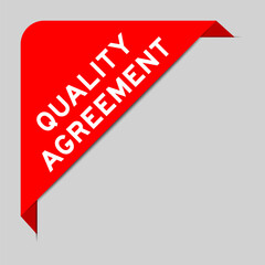 Sticker - Red color of corner label banner with word quality agreement on gray background