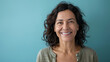 © Wonderful Studio - A woman with curly hair is smiling and looking at the camera