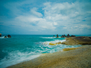 Wall Mural - Aerial panorama of Thailand's verdant with blue and aquamarine the sea, and clouds shining by sunlight in the background.