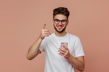 Wall Mural - Man showing smartphone, hand pointing banner, clever thought, quote pointing finger on light brown