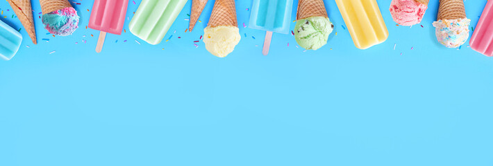 Leinwandbilder - Selection of colorful pastel ice cream cones and popsicle summer frozen desserts. Above view top border on a blue banner background. Copy space.
