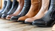   A line of women's boots aligned on a hardwood floor
