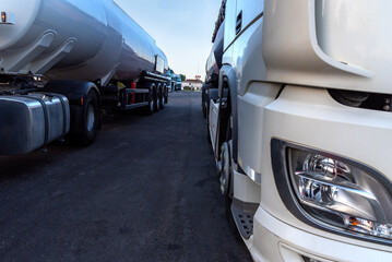 Wall Mural - Tanker trucks parked next to a restaurant in a parking lot with more trucks.