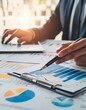 © Eggy - Professional Analysing Graphs and Charts - Financial Accountant studying Numbers - Business Audit - Finance Managers making up Balance - Analyst working at a Desk - Data Strategy - Stockbroker