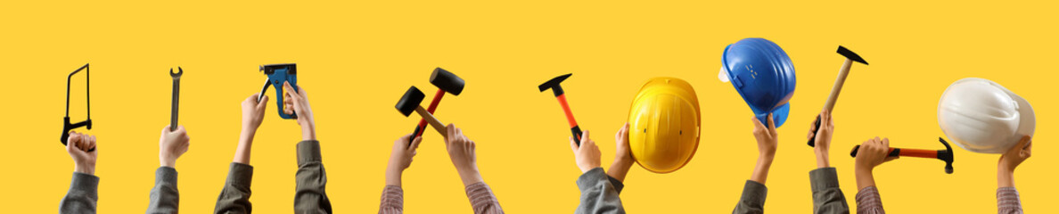 Wall Mural - Female hands holding different construction tools on yellow background