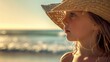 A happy little girl, wearing a sun hat, is standing on the beach looking at the azure ocean. Her fedora hat matches the color of the sky AIG50