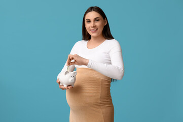 Sticker - Pregnant young woman with piggy bank and money on blue background