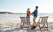 Couple, love and dance at beach for date, relationship and holding hands for support in nature. Man, woman and romance in summer for vacation, holiday and relax on tropical island for picnic