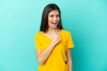 Wall Mural - Young caucasian woman isolated on blue background celebrating a victory