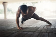 Black man, push up and shirtless in city with fitness, balance and healthy muscle with power on ground. Person, bodybuilder and outdoor on concrete for wellness, training and exercise in Los Angeles