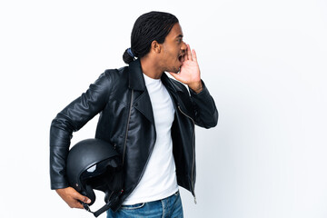 Wall Mural - African American man with braids holding a motorcycle helmet isolated on white background shouting with mouth wide open to the side