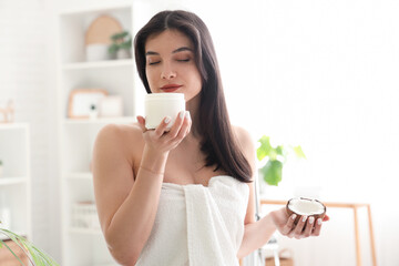 Sticker - Beautiful young happy woman with jar of hair mask and coconut in bathroom at home