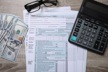 Wall Mural - Payroll. Tax return forms, dollar banknotes, glasses and calculator on wooden table, flat lay