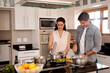 Couple, cooking and kitchen at home, supper and romantic with bonding, relationship and nutrition. Preparation, meal and people for healthy food, stove and teamwork in diet, marriage and vegetables