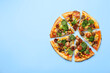 Delicious vegetarian pizza with mushrooms, vegetables and parsley on light blue background, top view. Space for text