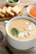 Healthy cream soup high in vegetable fats on wooden table, closeup