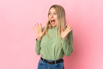 Wall Mural - Young blonde woman isolated on pink background with surprise facial expression