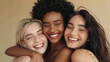 © Jazmyn Vision  - Portrait of happy multicultural girls hugging on beige background