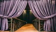 sophisticated purple stage curtains draped elegantly in a dark theater setting ready for a show