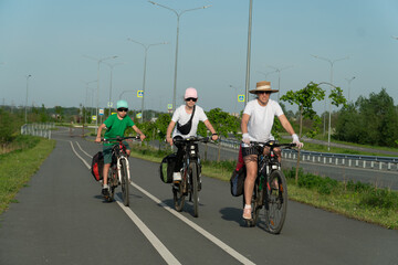 Wall Mural - family riding a bike, family sport, teenagers riding a bike, cycling, traveling, traveling on a bike,