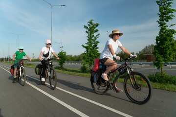 Canvas Print - family riding a bike, family sport, teenagers riding a bike, cycling, traveling, traveling on a bike,