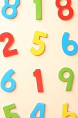 Poster - Colorful numbers on beige background, flat lay