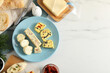 Different types of tasty butter, dill, chili and bread on white marble table, top view. Space for text