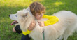 Child and dog outdoor portrait. Kids friend. Kid hugging dog in the park. Kid hugs a dog in the park. Pets and Childhood. Kids Life style with dogs. Kid plays with a husky dog in park.