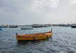 Yellow fishing boat in port of Marzamemi village on the island of Sicily, Italy