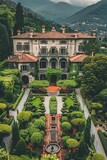 Fototapeta  - An Italian Renaissance villa with terracotta roofs is seen from above, surrounded by a garden in the front. The house features traditional architecture and the garden is lush and well-maintained
